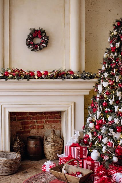 Christmas tree and decorated fireplace with gifts.