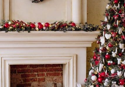 Christmas tree and decorated fireplace with gifts.
